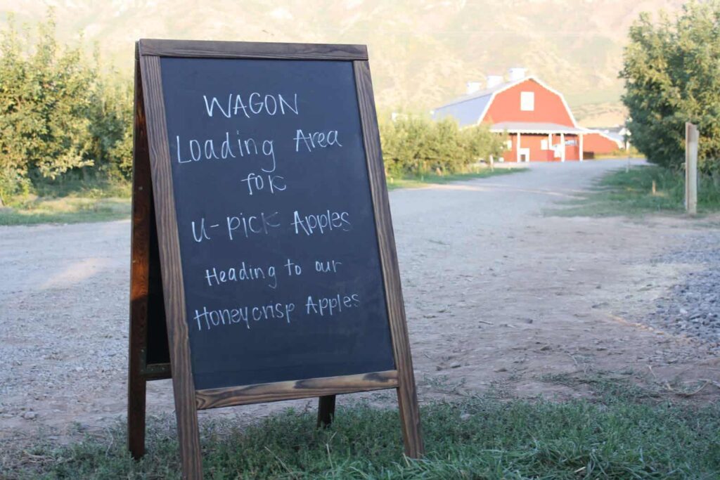 Chalk board with red barn in background