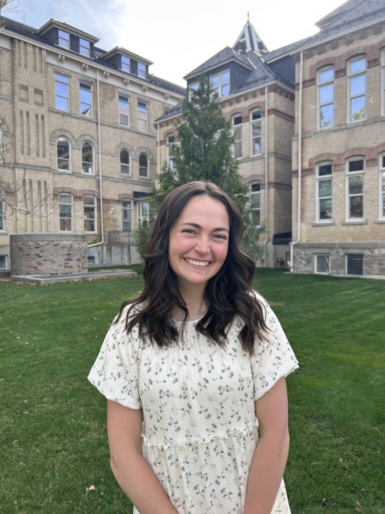 Mackenzie standing in front of old main at Utah State University